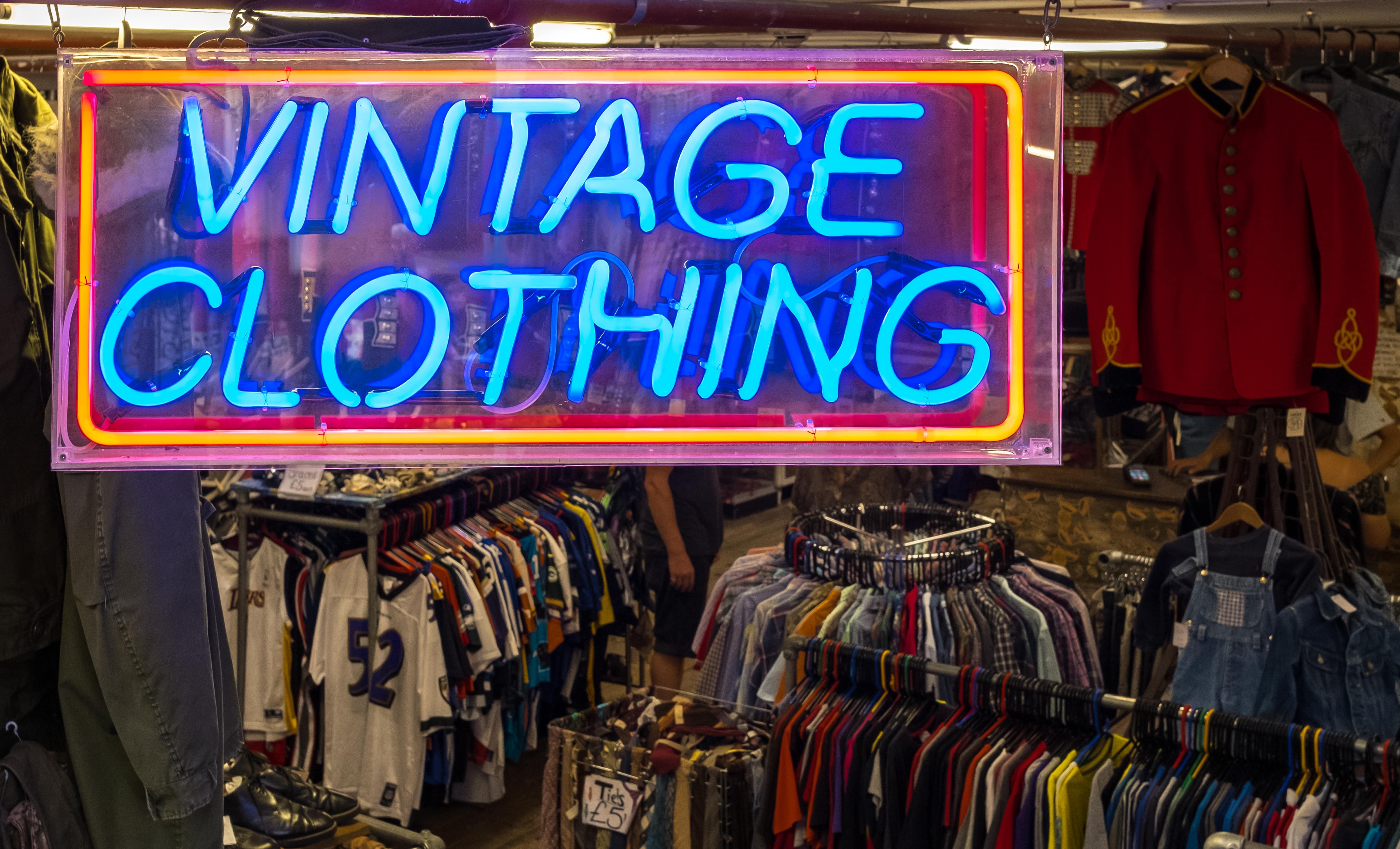 Vintage clothing illuminated sign using neon lights. 