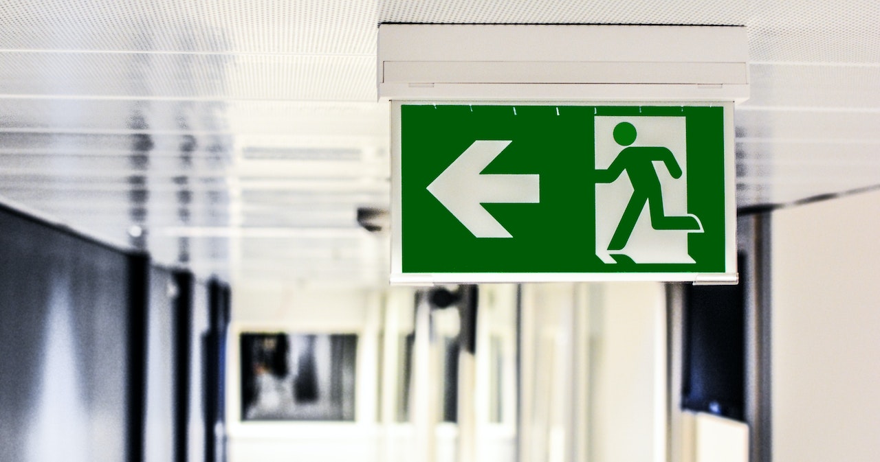 An emergency exit sign in an interior corridor providing clear direction for people during an emergency